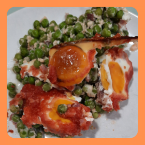 Huevos escalfados al horno con guisantes, tomate y jamón
